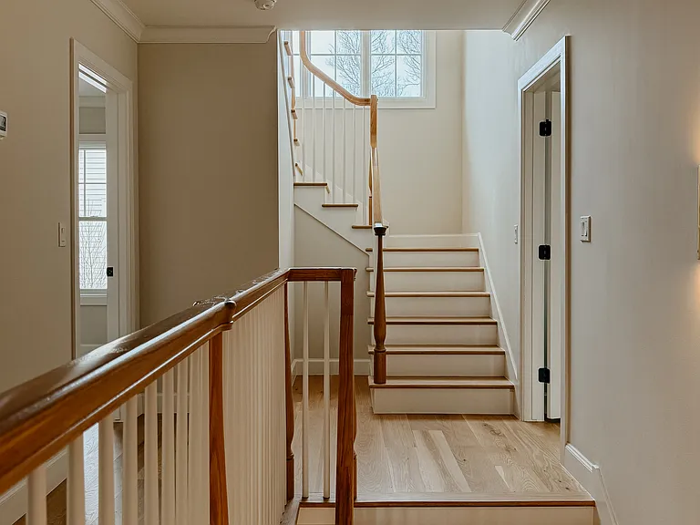 Landing at top of stairs with stairs to 3rd floor entertainment room and 4th bedroom