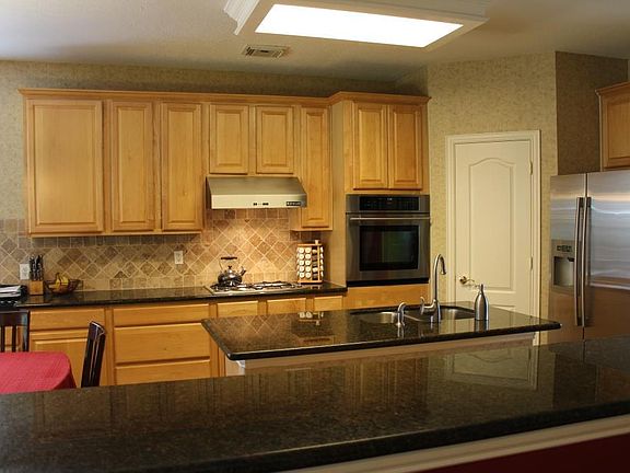 The cook in the family will love this kitchen. There's lots of cabinets and granite counters. The appliances are stainless with a gas cook top.