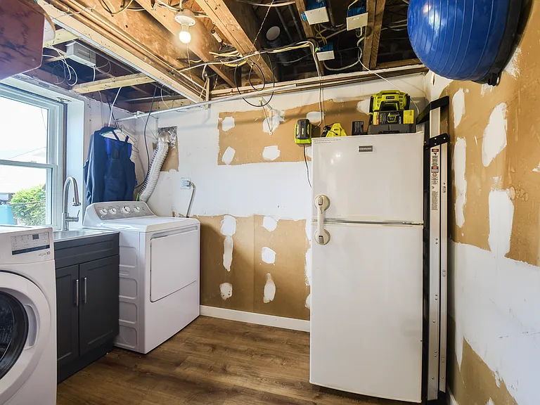 Laundry room with extra fridge and large stainless steel laundry sink