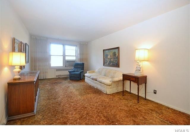 Large living room opens to the dining foyer and has covered hardwood floors.  The living room is 19'-4" x 11'-6"   The dining foyer is 15'-2" x 8'-2".