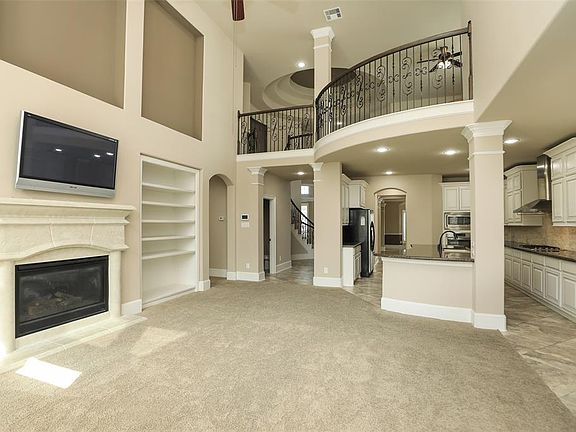 2 story family room with stone fireplace, bookshelves and art niches!