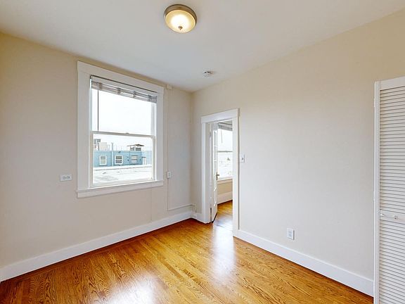 Bright bedroom with wood-like floor