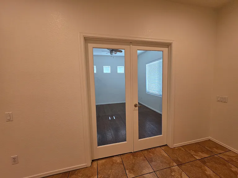 Bonus room with French doors.