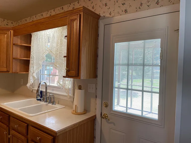 Lots of natural light in kitchen. Exterior door to screened in porch. Open and enjoy the outside.