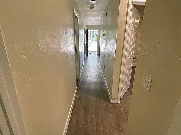 Hallway to shared bathroom and bedrooms