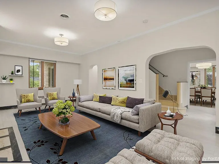 Well-lit living room with gracious openings to the kitchen and formal dining room