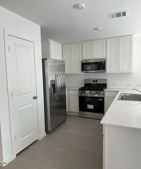 Kitchen fully equipped with stainless steel appliances.