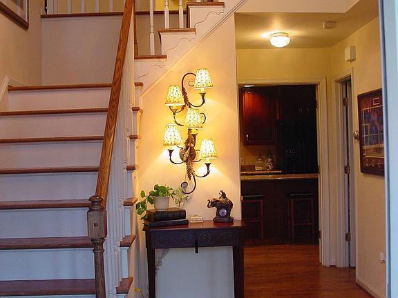 Two Story Foyer w/ Oak Staircase & Wood Floor