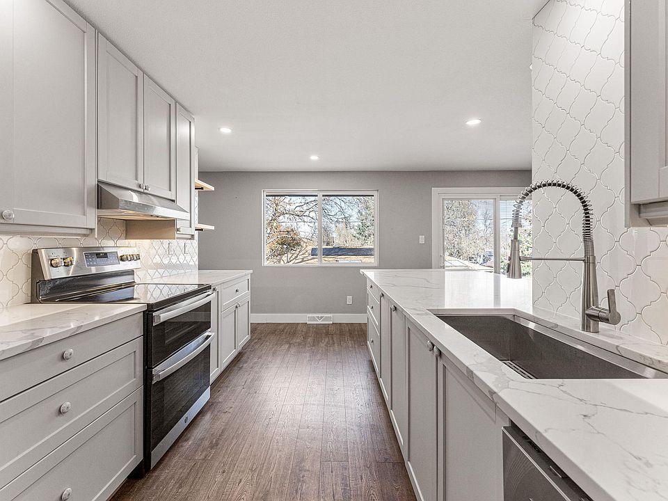 The beautiful new kitchen with quartz counters, stainless appliances and double oven is bathed in natural light.