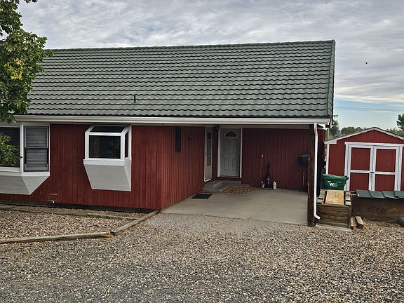 Back door entrance, carport and storage shed