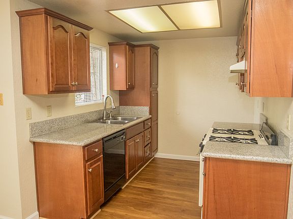 Kitchen with cherry cabinets and new flooring.