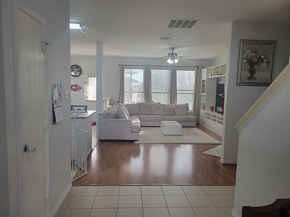 Another view of the living room with staircase leading upstairs.