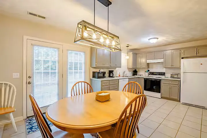 Kitchen has solid surface counters and subway tiled backsplash. Full size washer and dryer is located in one of the closets in the kitchen with bifold doors. Full size pantry closet and utility closet also off the kitchen.