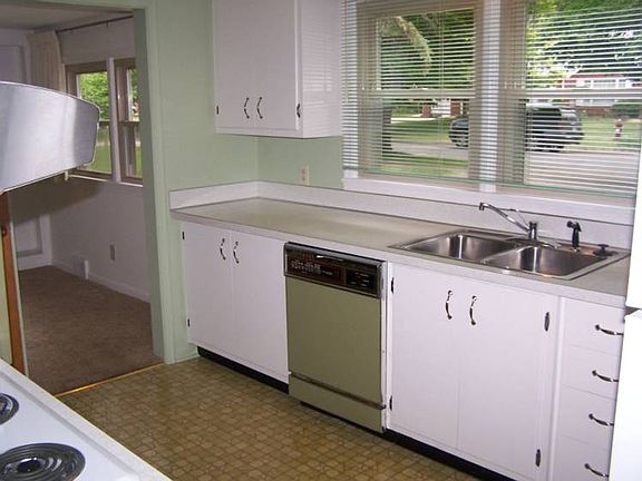 Freshly painted kitchen offers newer refrigerator and brand new range top.