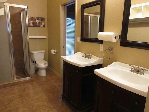 Large Bathroom with Two Entrances, Two Sinks and Stand Up Shower