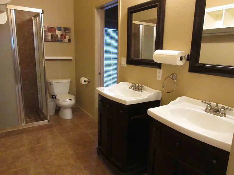 Large Bathroom with Two Entrances, Two Sinks and Stand Up Shower