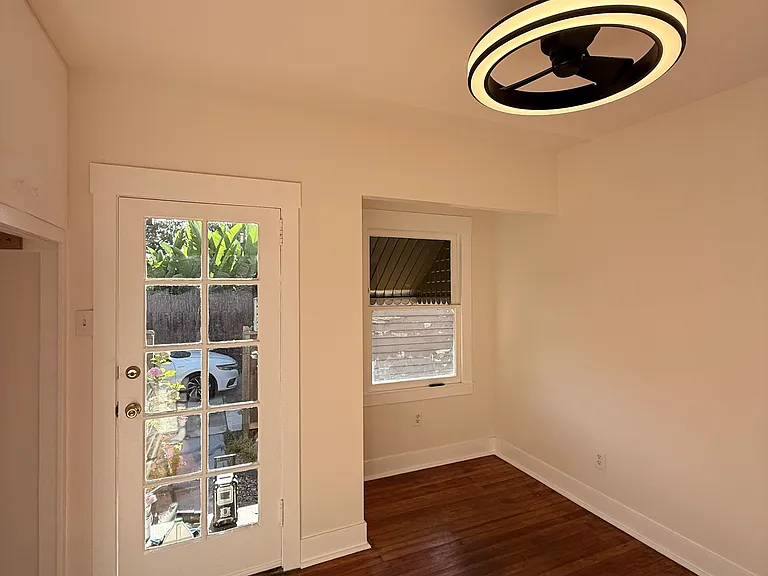 Living room w window nook to private front yard.
