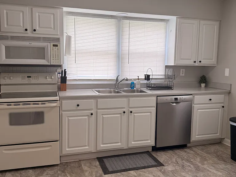 Large Kitchen. Dishes, Glassware, Pots and Pans, Crockpot, Coffee Maker, Microwave, Full Size Refrigerator.