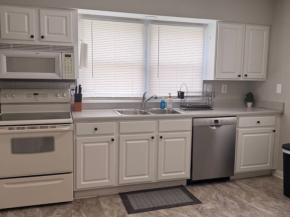 Large Kitchen. Dishes, Glassware, Pots and Pans, Crockpot, Coffee Maker, Microwave, Full Size Refrigerator.