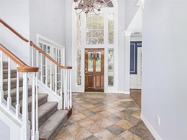 Grand foyer with new carpet on stairs