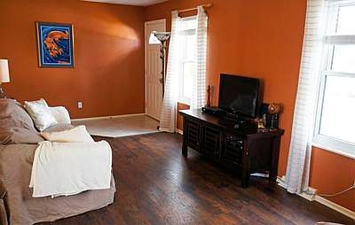 Tile entryway leads to the living area with beautiful new curtains and blinds.