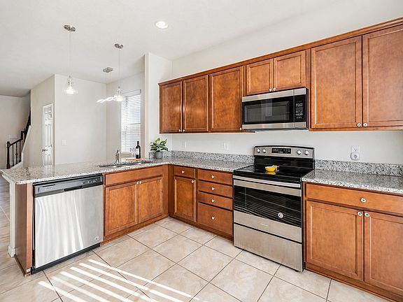 Spacious kitchen with stainless steel appliances and generous counter space