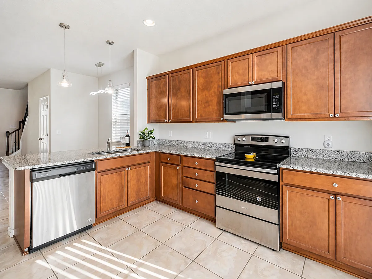 Spacious kitchen with stainless steel appliances and generous counter space - 3566 Southern Cross Loop