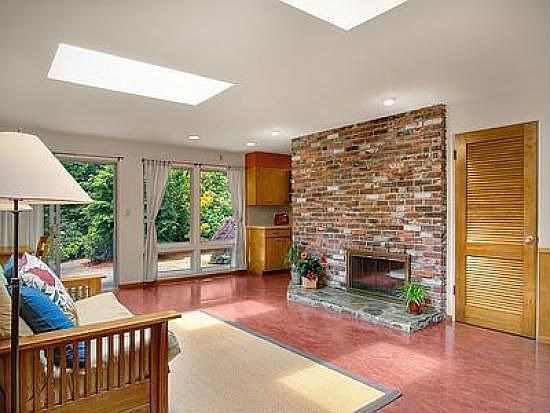 Family room has skylights, gas fireplace, and eco-friendly marmoleum