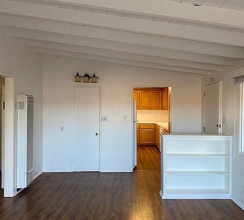 Another view of living space with peak into kitchen area