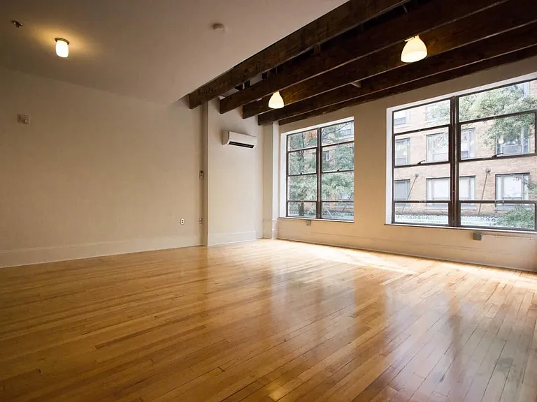 Sample of original 1920s hardwood flooring, windows and open wood-beamed ceilings.