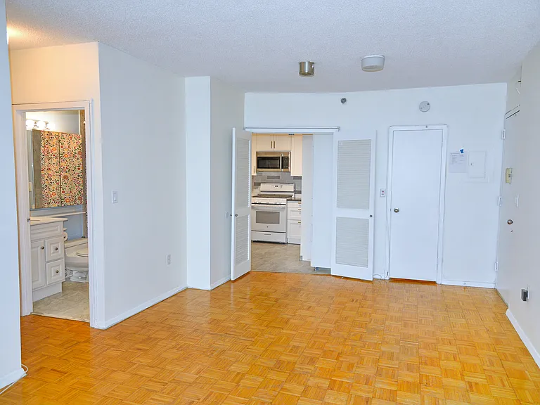 Living room entrance, walk-in closet, kitchen and bathroom