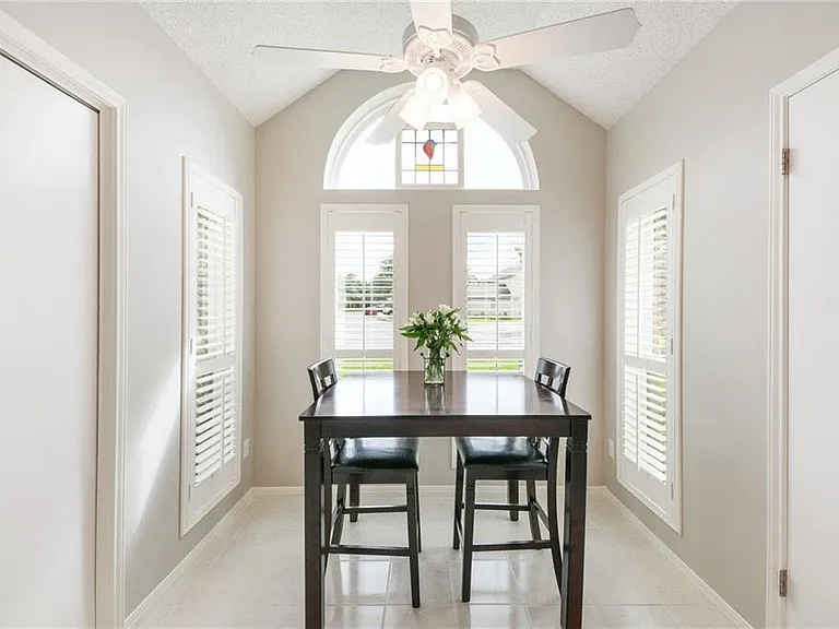 Breakfast nook overlooking front yard. Plantation shutters in the windows.