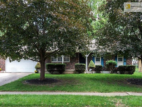 Mature trees and brick front