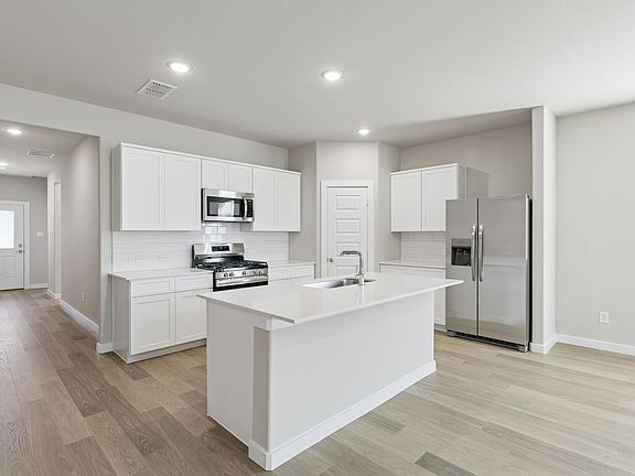 Kitchen in the Holden home plan by Trophy Signature Homes - REPRESENTATIVE PHOTO