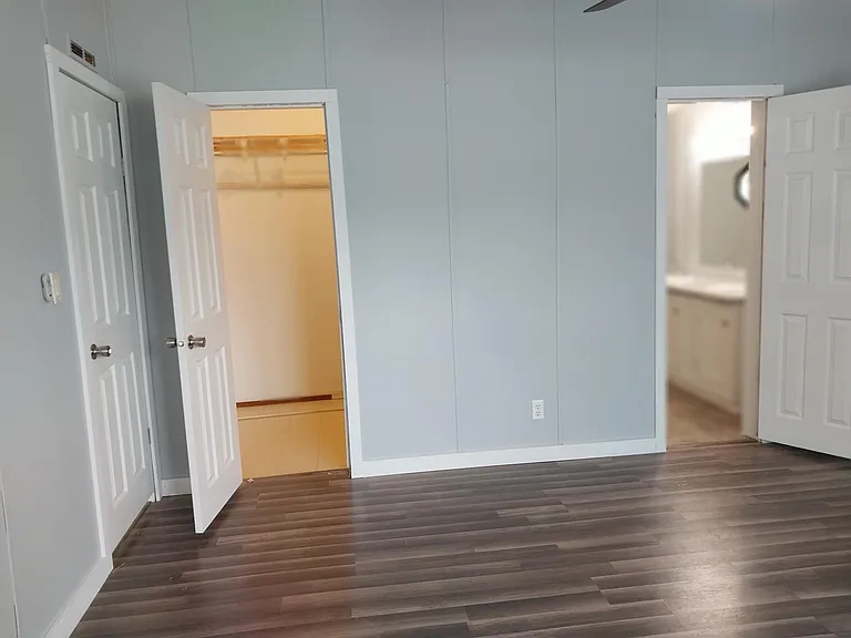 Primary bedroom with view of walk-in closet and bathroom