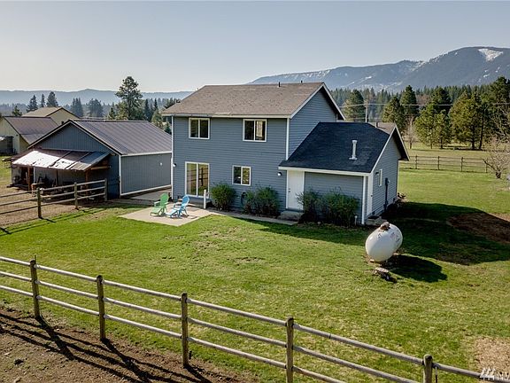 Large fenced backyard with patio off dining area.  Chicken coup just beyond fenced yard.