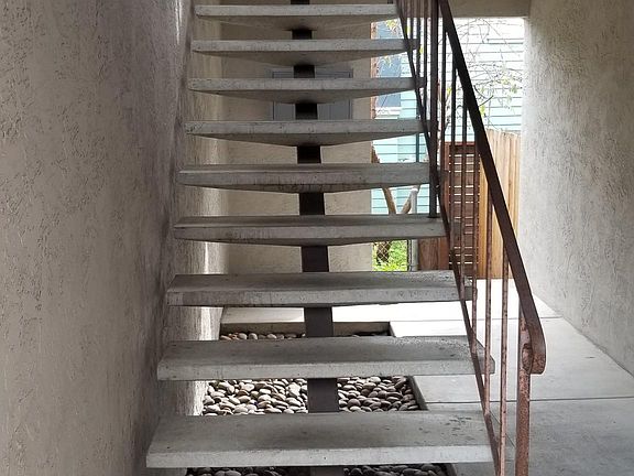 Stairs leading to the apartment on the second floor.