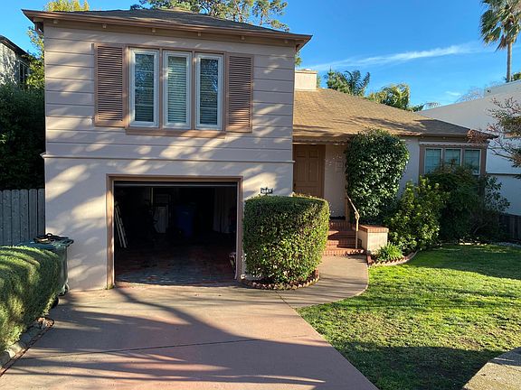 Front of house, garage door open