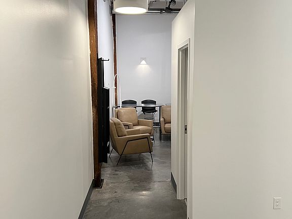 entrance to condo -- Cement floors -- bedroom to right - living room/kitchen straight ahead.