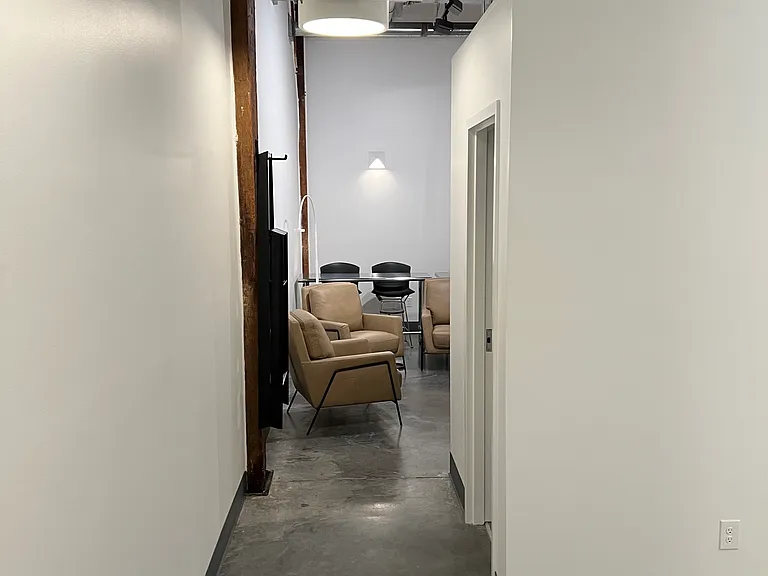entrance to condo -- Cement floors -- bedroom to right - living room/kitchen straight ahead.