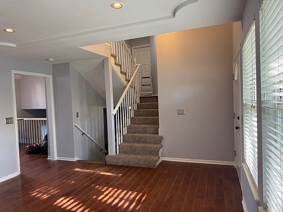 Living room just inside the front door. Stairs up to bedrooms. Stairs down to fireplace room. Kitchen on this same level.