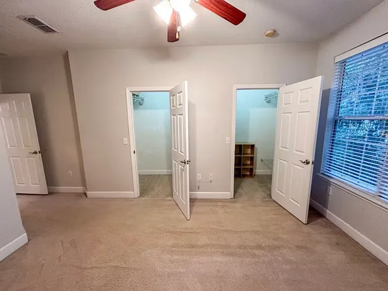 Primary bedroom with double walk-in closets
