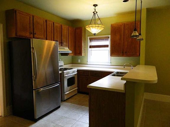 Renovated kitchen with breakfast bar opening to den