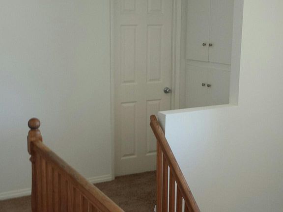Top of stairs with door to 2nd Bathroom and Linen closets.