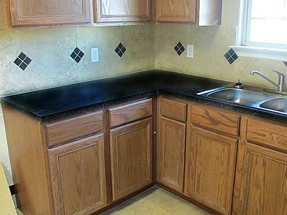 Chef s delight kitchen with look out window and tumbled decorator backsplash