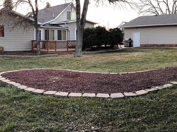 Backyard facing side of garage and shed on right