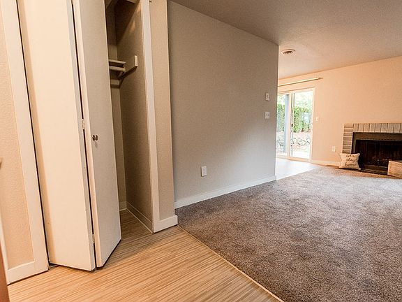 Tacoma Apartments - Notch8 Apartments - Entryway, Hall Closet, Living Room, Fireplace, and Patio