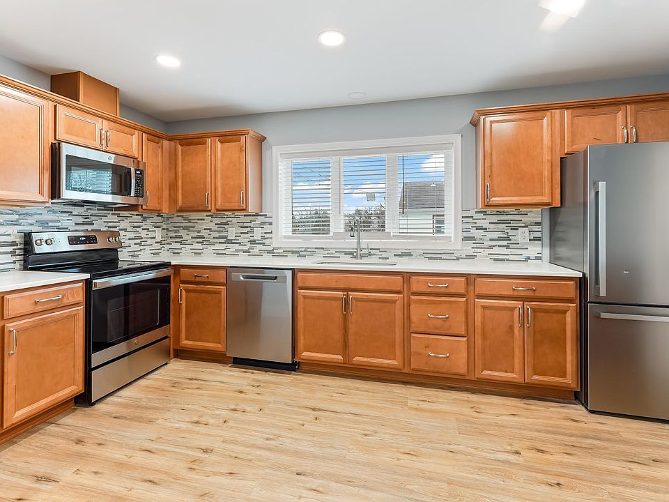 New kitchen cabinets, granite countertops, tiled backsplash, appliances and flooring.