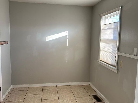 Laundry room with door to garage and back patio