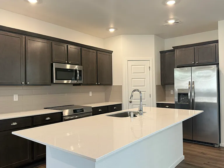 Kitchen with stainless steel appliances and quartz countertops